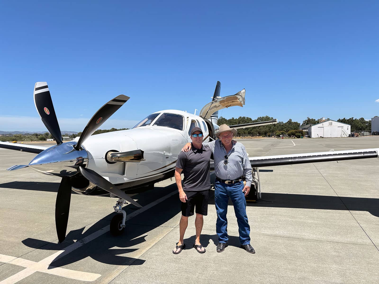 Pilot JR Osborne with his dad Gene in front of their TBM850 after a successful aircraft closing and completing his TBM850 Initial Training.